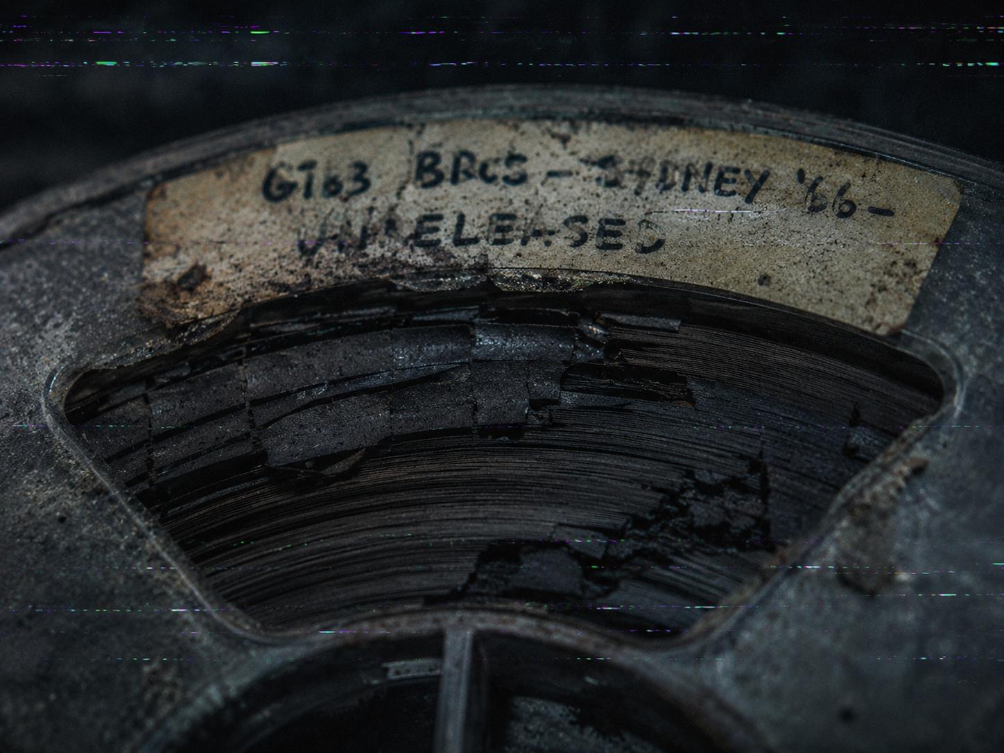 Close-up of a decaying 1966 master tape reel with a faded handwritten label for the Bee Gees Sydney sessions.
