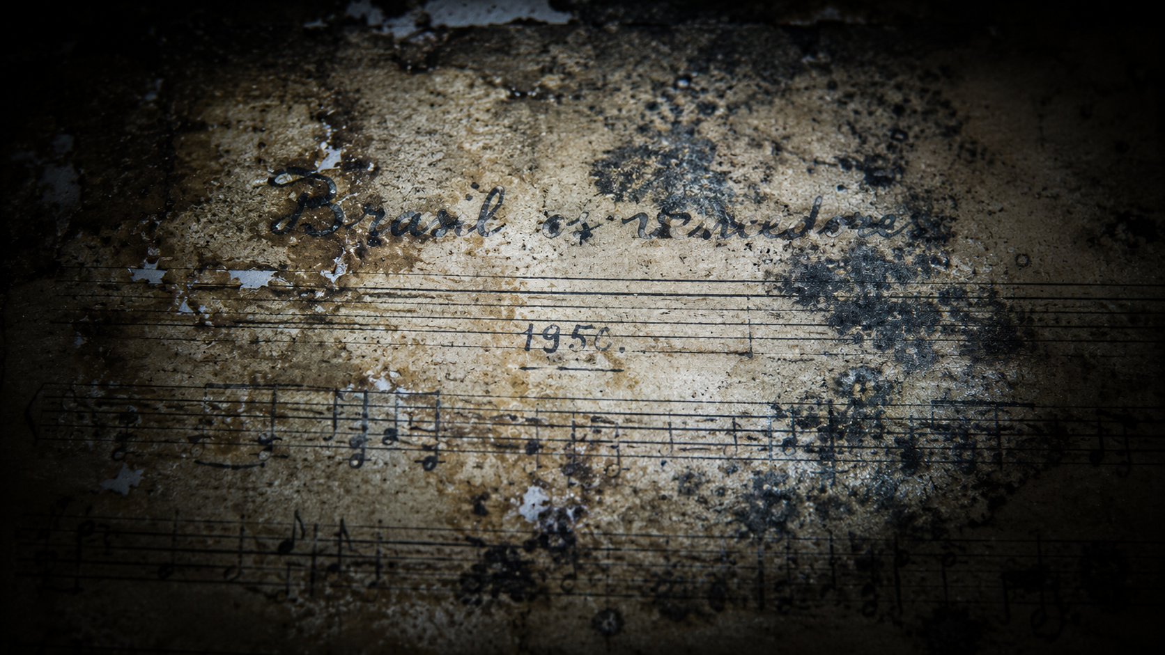 Macro close-up view of a stained, decaying 1950 sheet music manuscript titled Brasil os vencedores under a forensic flashlight.