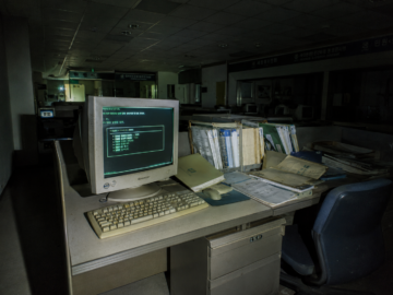 The Peep Variant: South Korea’s Classified 2004 State-Level Network Purge Flashlight lit forensic photograph of a glowing 2004 South Korean government computer terminal in a dark office.